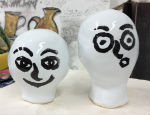 Trying out painting faces on glazed test pieces for ceramics project  