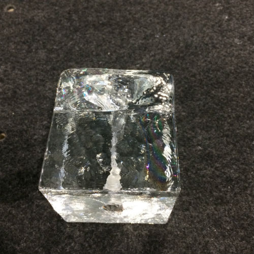 Cast glass cube with collapsed hole through it