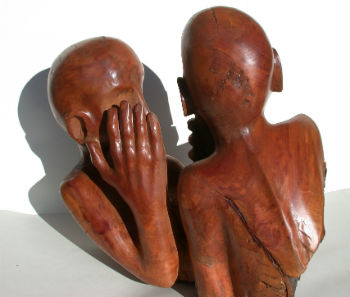 Carving of two people whispering by Peter Heywood