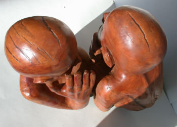 Cherry wood sculpture of people whispering to each other by Peter Heywood